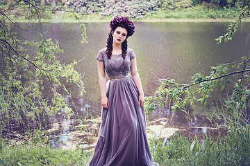 Image showing girl in dress in rhododendron garden