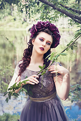 Image showing girl in dress in rhododendron garden