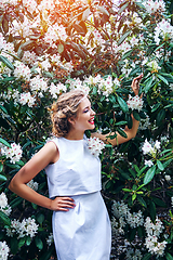 Image showing girl in dress in rhododendron garden