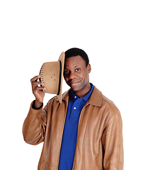 Image showing Handsome man standing in a leather jacket and hat