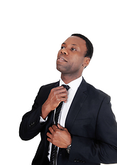 Image showing African business man fixing his tie