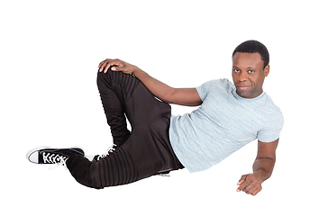 Image showing Handsome African man sitting on floor resting