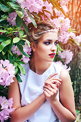 Image showing girl in dress in rhododendron garden