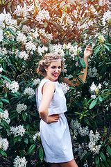 Image showing girl in dress in rhododendron garden