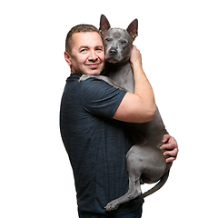 Image showing man holding thai ridgeback dog