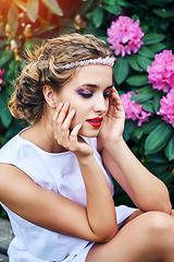 Image showing girl in dress in rhododendron garden