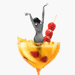 Image showing Contemporary art collage, modern design. Summer mood. Tender ballerina sitting on giant cocktail glass with yellow berry drink