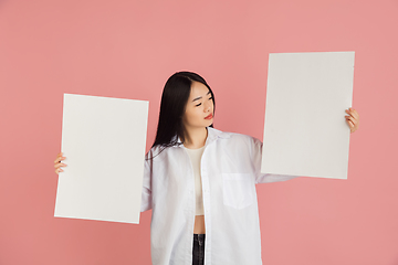 Image showing Asian young woman\'s portrait on pink studio background. Concept of human emotions, facial expression, youth, sales, ad.