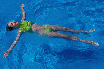 Image showing teen girl relaxing near swimming pool