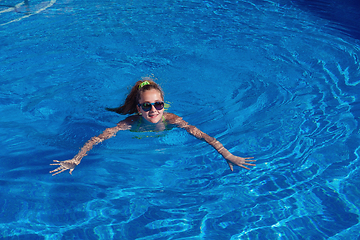 Image showing teen girl relaxing near swimming pool