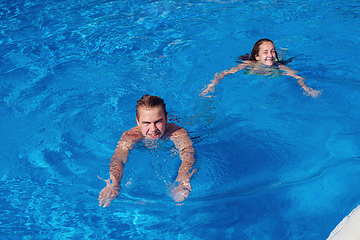 Image showing boy and girl having fun in swimming pool