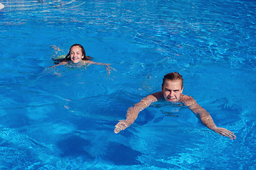 Image showing boy and girl having fun in swimming pool