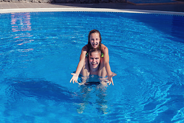 Image showing boy and girl having fun in swimming pool