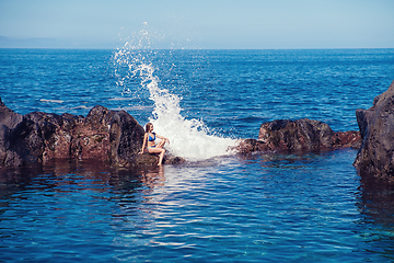 Image showing beautiful girl resting in natural ocean swimming pool