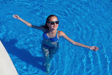 Image showing teen girl relaxing near swimming pool