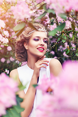 Image showing girl in dress in rhododendron garden