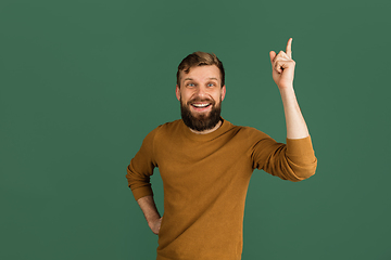 Image showing Caucasian man\'s portrait isolated over green studio background with copyspace