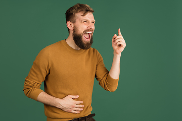 Image showing Caucasian man\'s portrait isolated over green studio background with copyspace