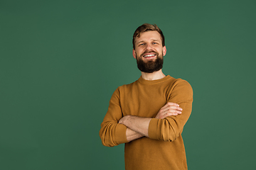 Image showing Caucasian man\'s portrait isolated over green studio background with copyspace