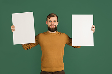 Image showing Caucasian man\'s portrait isolated over green studio background with copyspace