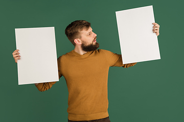 Image showing Caucasian man\'s portrait isolated over green studio background with copyspace