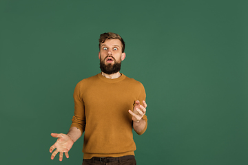 Image showing Caucasian man\'s portrait isolated over green studio background with copyspace