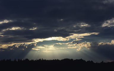 Image showing Dark Dramatic Sky with Sunbeams Through Storm Clouds