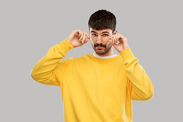 Image showing young man in glasses and yellow sweatshirt