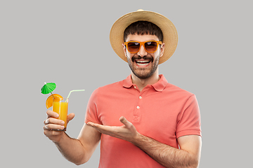 Image showing happy man in straw hat with orange juice cocktail