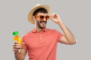 Image showing happy man in straw hat with orange juice cocktail