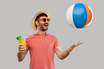 Image showing happy man with orange juice and beach ball