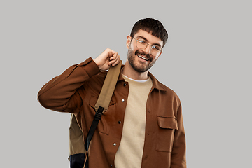 Image showing smiling young man in glasses with backpack