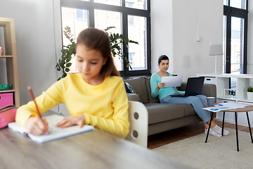 Image showing mother working and daughter studying at home