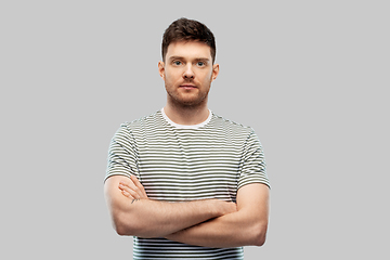 Image showing young man in striped t-shirt with crossed arms