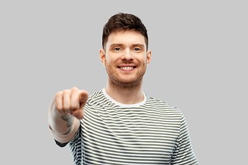 Image showing man in yellow sweatshirt pointing finger to camera