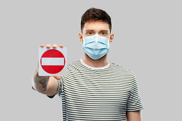 Image showing young man girl in medical mask showing stop sign