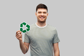 Image showing smiling young man holding green recycling sign