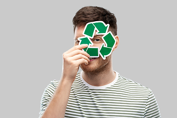 Image showing smiling young man holding green recycling sign