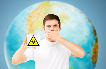 Image showing scared man with biohazard sign over earth planet