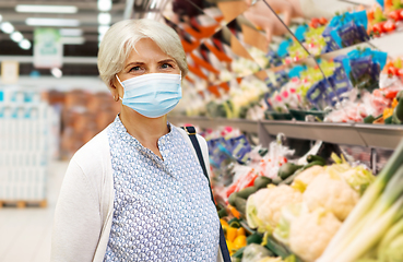 Image showing senior woman in medical mask at supermarket