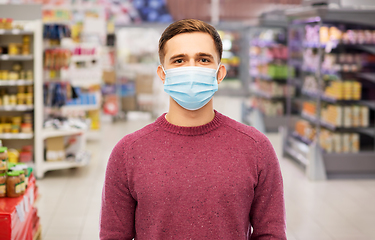 Image showing young man in medical mask at supermarket