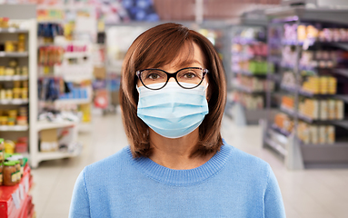 Image showing senior woman in medical mask at supermarket