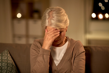 Image showing unhappy senior woman suffering from headache