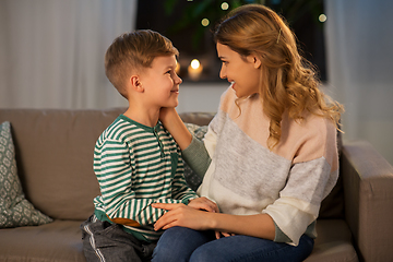 Image showing happy smiling mother talking to her son at home