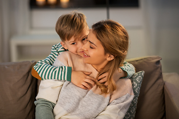 Image showing happy smiling mother and son hugging at home