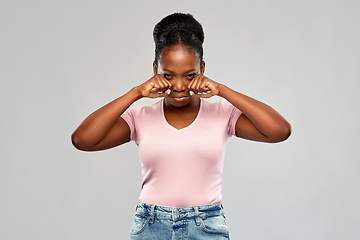 Image showing sad african american woman making crying gesture