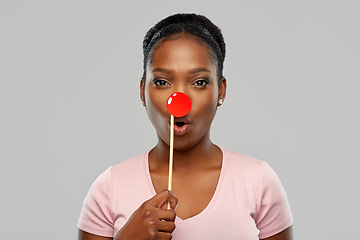 Image showing surprised african woman with red clown nose