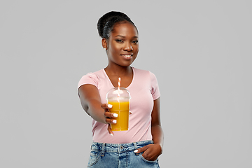 Image showing happy african american woman drinking orange juice