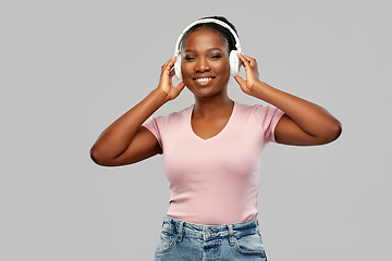 Image showing african woman in headphones listening to music