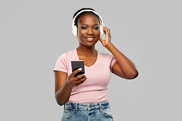 Image showing african woman in headphones listening to music